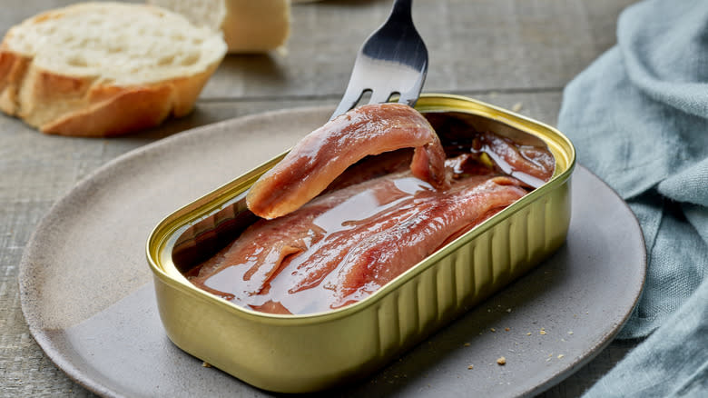 Anchovies in tin with fork