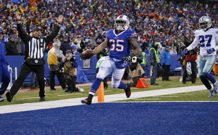 Dec 27, 2015; Orchard Park, NY, USA; Buffalo Bills running back Mike Gillislee (35) runs 50 yards for a touchdown as Dallas Cowboys free safety J.J. Wilcox (27) pursues during the second half at Ralph Wilson Stadium. The Bills defeat Cowboys 16-6. Mandatory Credit: Kevin Hoffman-USA TODAY Sports
