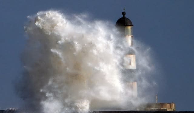 Waves hit the lighthouse at Seaham in Durham 