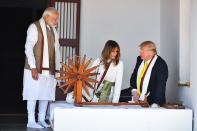 US President Donald Trump (R) and First Lady Melania Trump (C) are accompanied by India's Prime Minister Narendra Modi as they visit the Gandhi Ashram in Ahmedabad on February 24, 2020. (Photo by Mandel NGAN / AFP) (Photo by MANDEL NGAN/AFP via Getty Images)