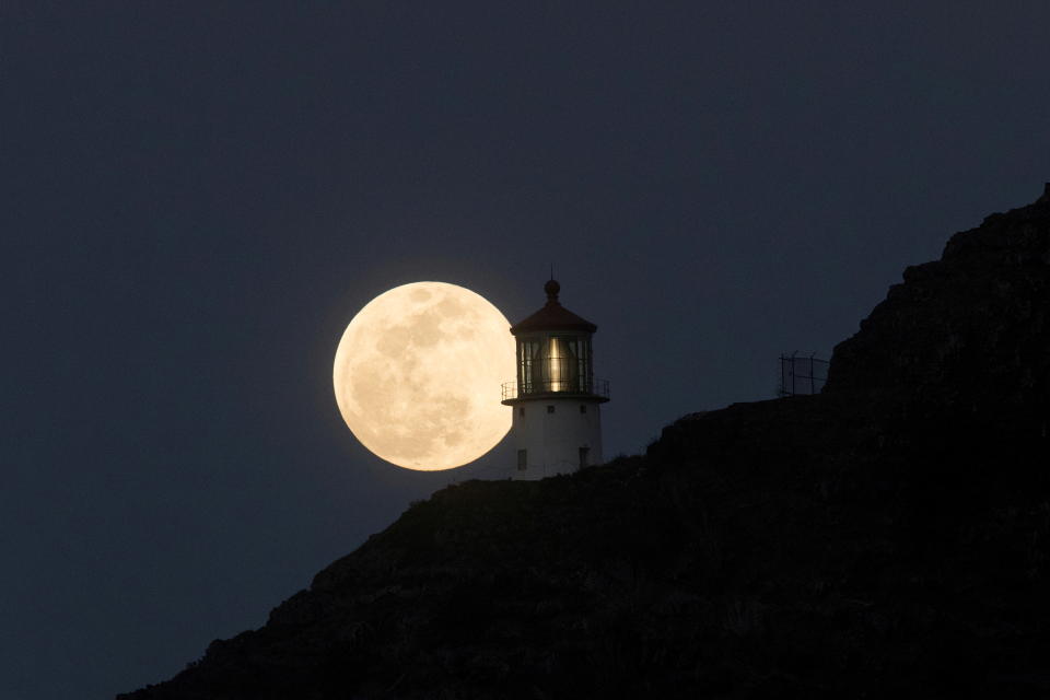 <p>A Super Flower Moon rises over the Makapuu lighthouse in east Oahu, Honolulu, Hawaii, U.S., May 25, 2021. Picture taken May 25, 2021. REUTERS/Marco Garcia TPX IMAGES OF THE DAY</p> 