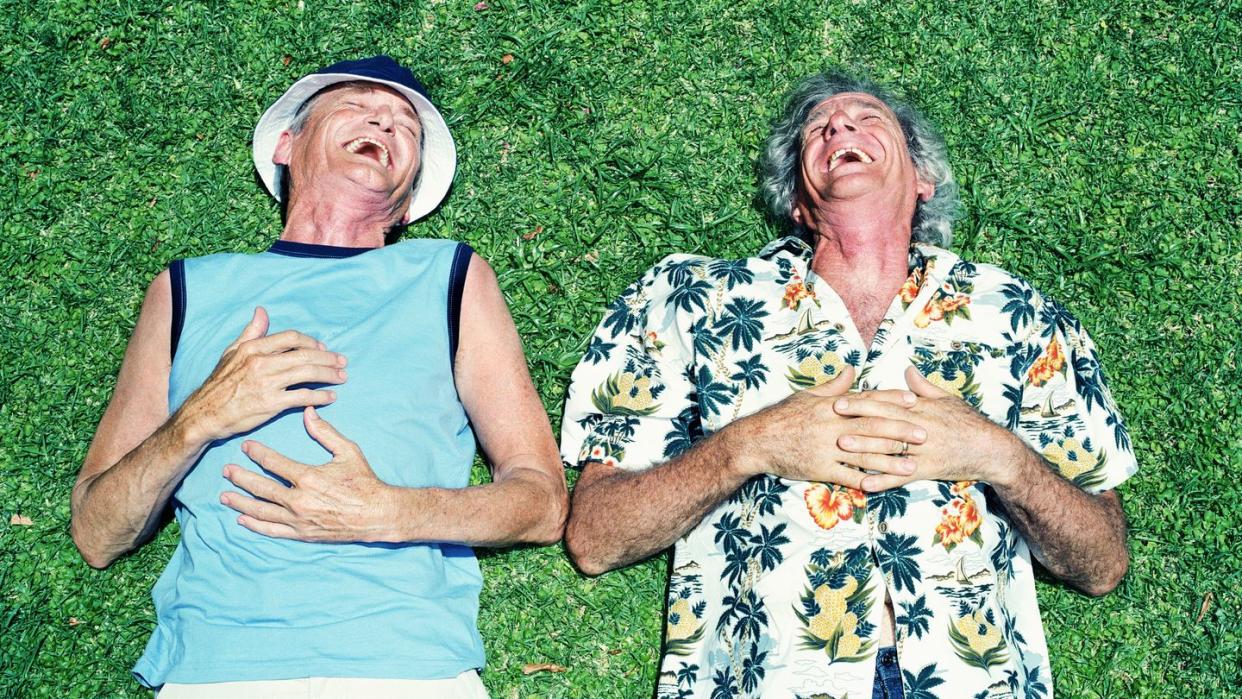 two men laughing on the grass funny birthday message