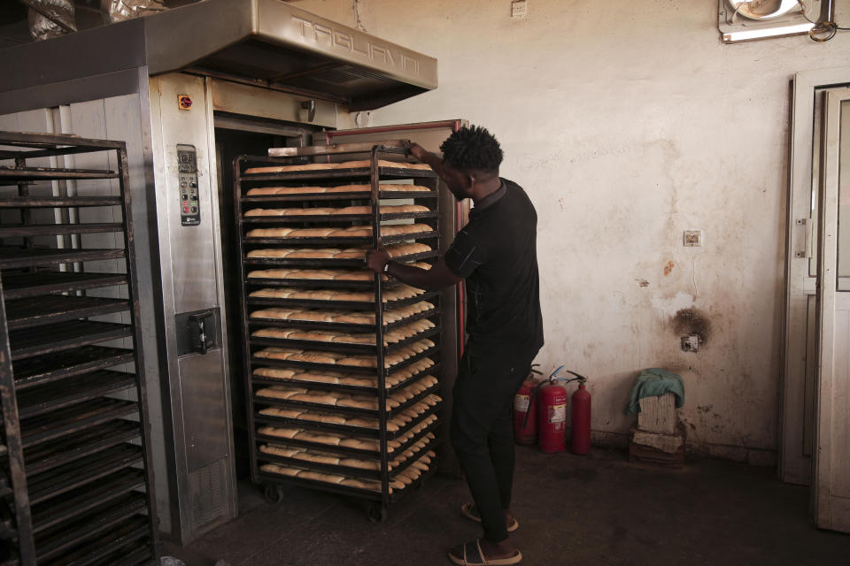 A man works in a bakery in Khartoum, Sudan, Wednesday, March.30, 2022. The UN has warned that more than 18 million people Sudanese, nearly half its population, could face severe hunger by this fall. (AP Photo/Marwan Ali)