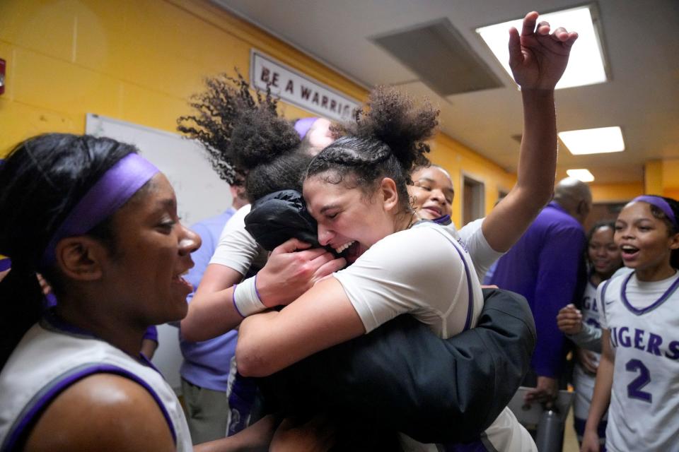 Pickerington Central's Olivia Cooper (center) hugs Central graduate Jocelyn Tate, who now plays for Bowling Green, after the Tigers beat Dublin Coffman.