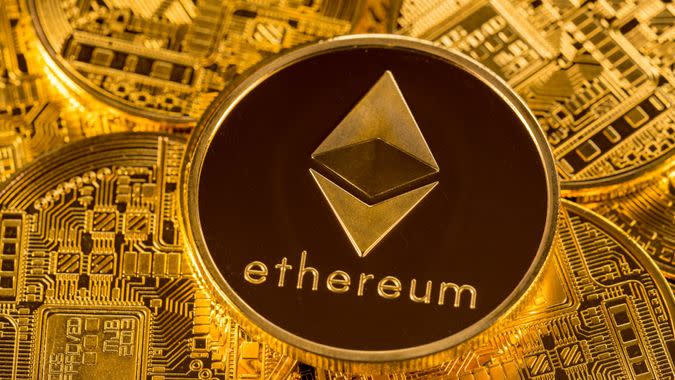 MORGANTOWN, WV - 31 DECEMBER 2017: Ethereum or ether coin lying on top of similar golden coins to illustrate cybercurrencies.