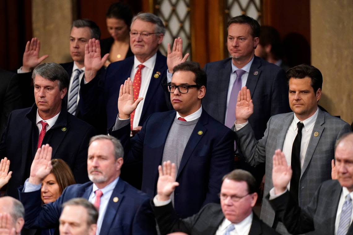 Rep. George Santos takes the oath of office. The fingers of his other hand were crossed. Alex Brandon/AP