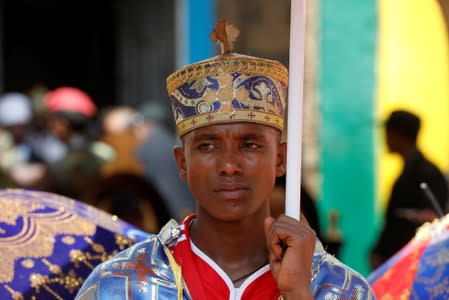 An Ethiopian Christian Orthodox clergyman attends the funeral of Amhara president Ambachew Mekonnen and two other officials in the town of Bahir Dar