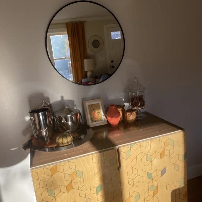 The circular mirror above the owners buffet with bar supplies