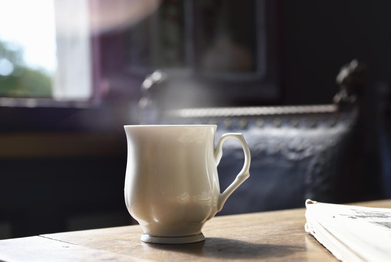 cup of tea on table with steam