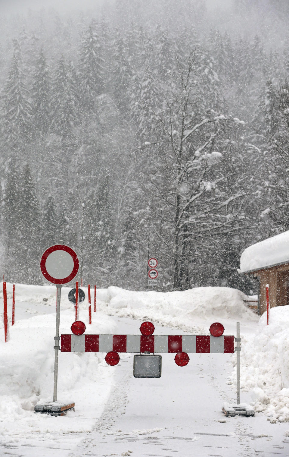 Due to the danger of an avalanche a mountain pass road is closed in Obermaiselstein, Germany, Sunday, Jan. 13, 2019. (Karl-Josef Hildenbrand/dpa via AP)