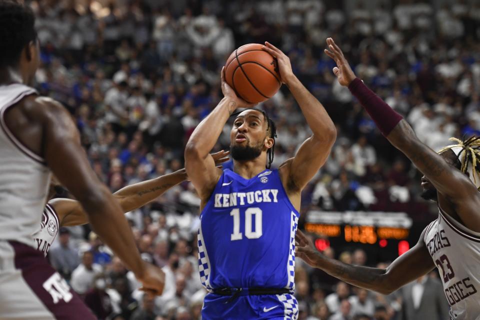 Kentucky guard Davion Mintz (10) shoots next to Texas A&M guard Tyrece Radford (23) during the first half of an NCAA college basketball game Wednesday, Jan. 19, 2022, in College Station, Texas. (AP Photo/Justin Rex)