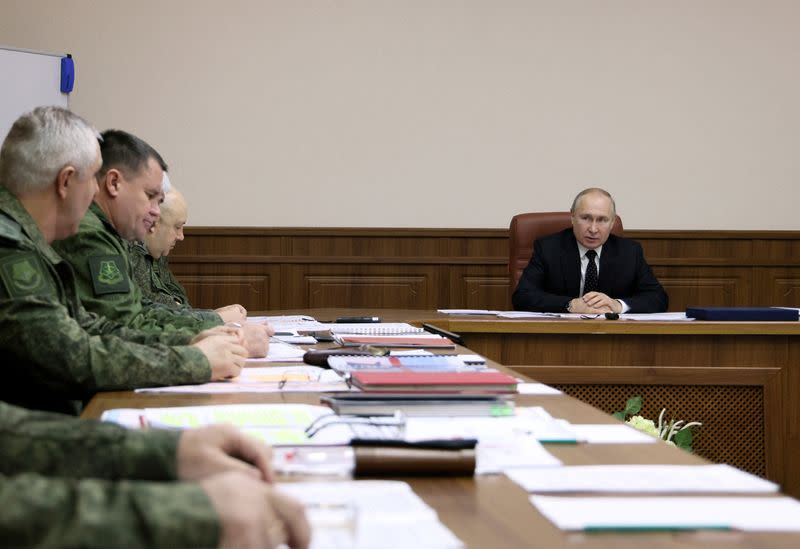Russian President Vladimir Putin visits the Joint Headquarters of the Russian armed forces, in an unknown location