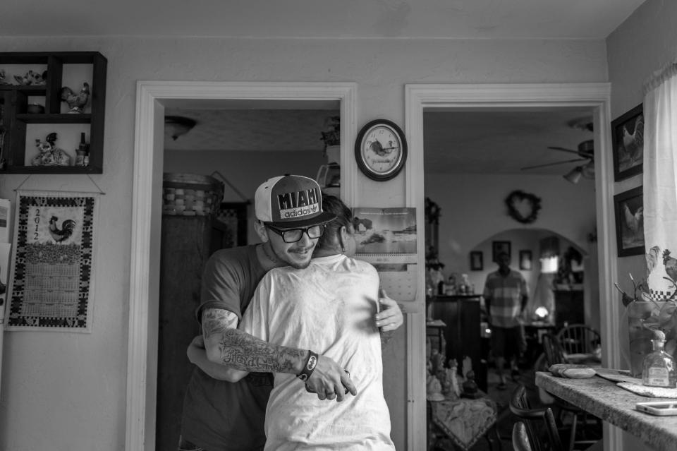 <p>Recovering heroin addict Larry Fugate, hugs his mom Terri Fugate at their home in Middletown, Ohio. (Photograph by Mary F. Calvert for Yahoo News) </p>