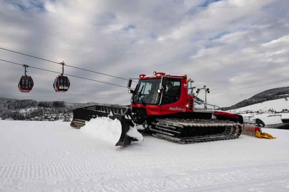 14 december 2022, hessen, willingen a pisten bully prepares a downhill slope next to cabins of the ettelsberg cable car willingen in the sauerland region starts the winter season in the evening with floodlit skiing photo swen pförtnerdpa photo by swen pförtnerpicture alliance via getty images