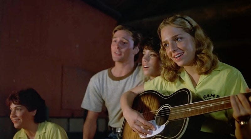 campers singing before Mrs. Voorhees kills them all.