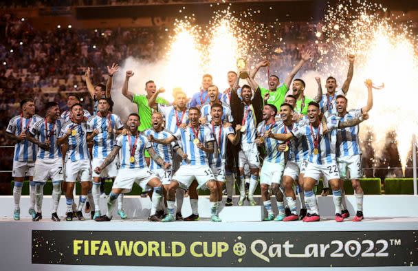 PHOTO: Argentina's Lionel Messi celebrates with the trophy and teammates after winning the World Cup in Lusail, Qatar, Dec. 18, 2022. (Carl Recine/Reuters, FILE)