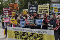 South Korean protesters shout slogans during a protest over the death of George Floyd, a black man who died after being restrained by Minneapolis police officers on May 25, near the U.S. embassy in Seoul, South Korea, Friday, June 5, 2020. The signs read: "The U.S. government should stop oppression and There is no peace without justice." (AP Photo/Ahn Young-joon)