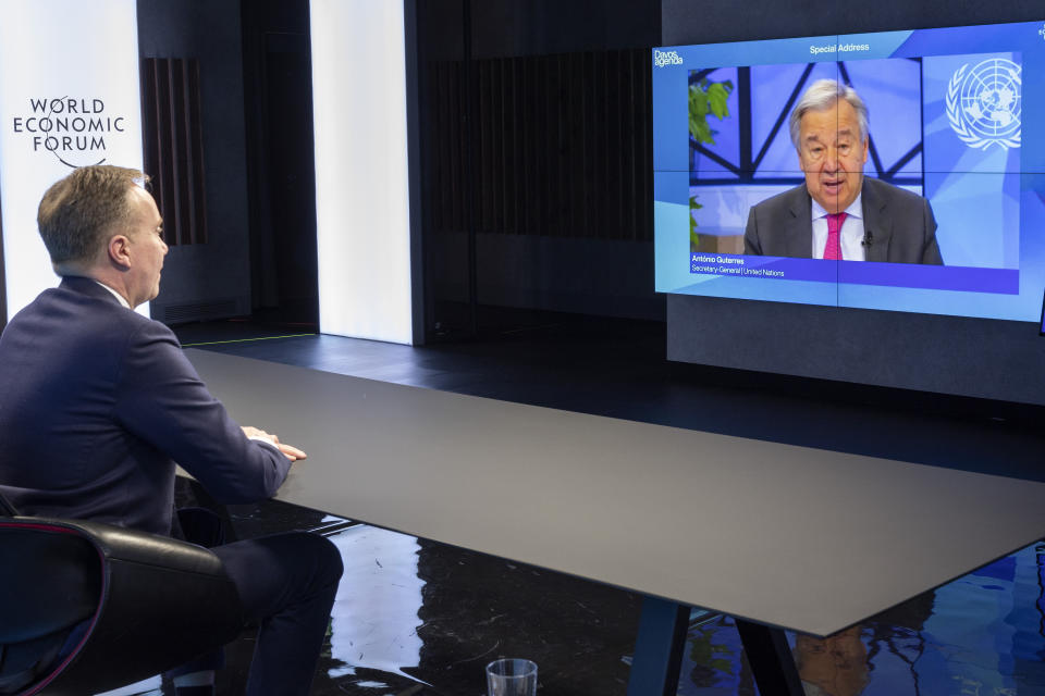 Borge Brende, President of the World Economic Forum (WEF), listens to the U.N. Secretary-General Antonio Guterres in a screen during the Davos Agenda 2022, in Cologny near Geneva, Switzerland, Monday, Jan. 17, 2022. The Davos Agenda, which takes place from Jan. 17 to Jan. 21, 2022, is an online edition of the annual Davos meeting of the World Economy Forum due to the coronavirus pandemic. (Salvatore di Nolfi/Keystone via AP)