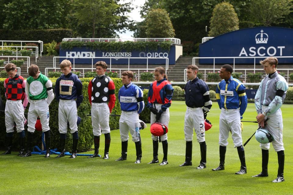 Jockeys at Ascot wear black armbands and observe a minute’s silence in memory of the three women (Getty)