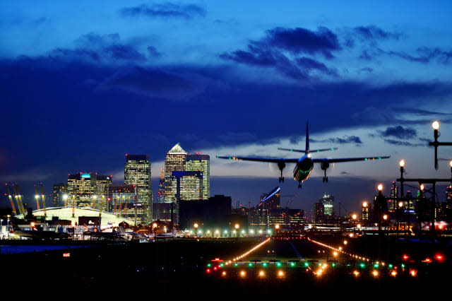Landing airplane and skyscrapers of Canary Wharf