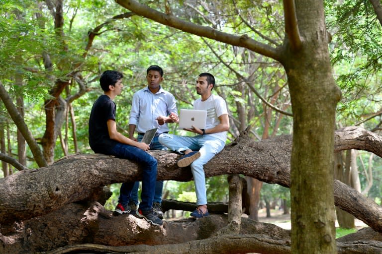 "Ethical hackers" Anand Prakash (R), Shashank (L), and Rohit Raj (C), who break into computer networks to expose rather than exploit weaknesses, meet at a public park in Bangalore