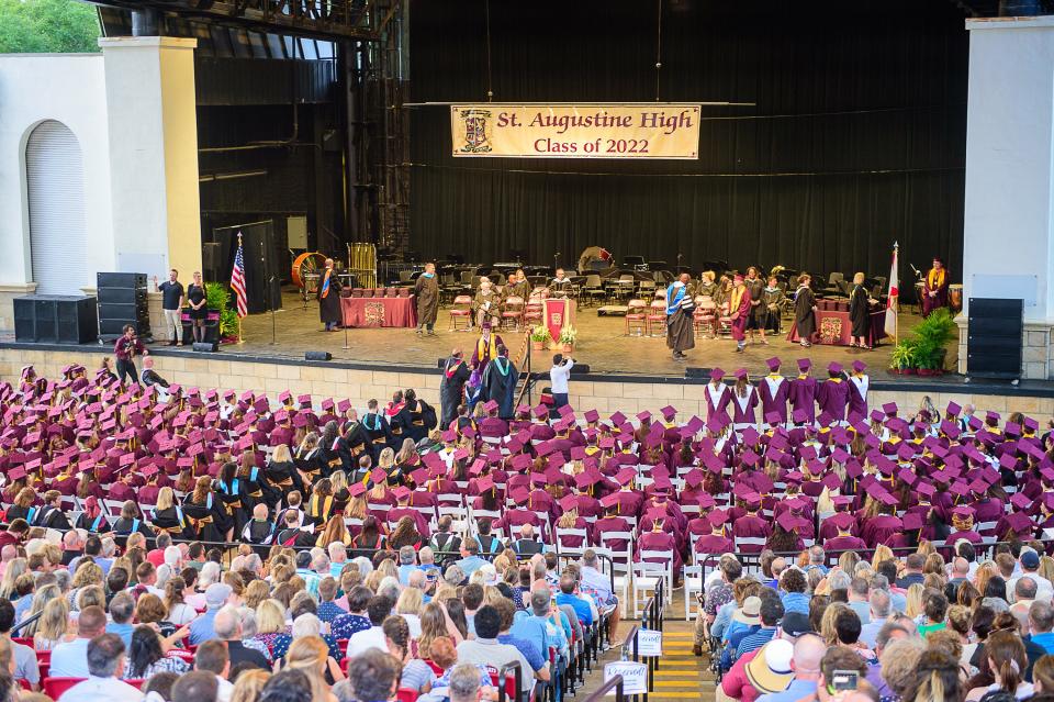 A St. Augustine High School graduate walks across the stage of the St. Augustine Amphitheatre to receive his diploma at the school's commencement ceremony on Thursday, May 26, 2022.