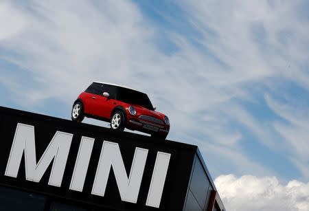 A Mini car is displayed on the roof of a Mini dealership in Brighton in southern England August 6, 2013. REUTERS/Luke MacGregor