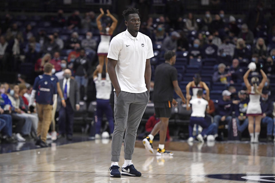 Connecticut's Adama Sanogo watches his team warm up before an NCAA college basketball game against Grambling State, Saturday, Dec. 4, 2021, in Storrs, Conn. (AP Photo/Jessica Hill)