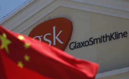 A Chinese national flag is seen in front of a GlaxoSmithKline office building in Shanghai in this July 12, 2013 file photo. REUTERS/Aly Song/Files