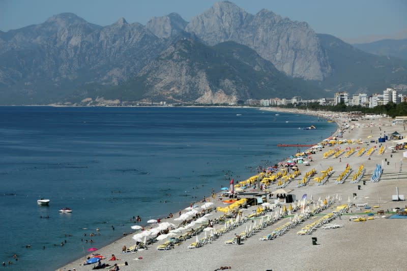 FILE PHOTO: Tourists enjoy a beach in the Mediterranean resort city of Antalya