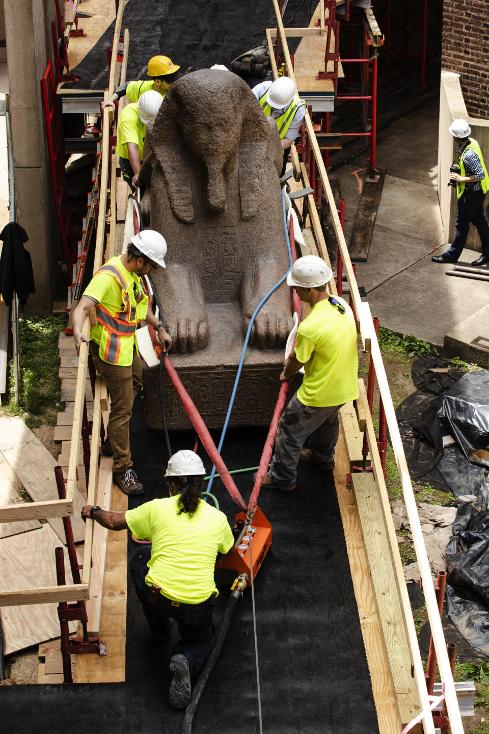 Workers move a 25,000-pound Sphinx of Ramses II at the Penn Museum in Philadelphia, Wednesday, June 12, 2019. The 3,000-year-old sphinx is being relocated from the Egypt Gallery where it's resided since 1926 to a featured location in the museum's new entrance hall. (AP Photo/Matt Rourke)