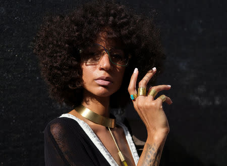 Aziza Nicole, a jewelry designer based in New York, poses for a portrait in the Brooklyn borough of New York, U.S., August 25, 2018. REUTERS/Caitlin Ochs