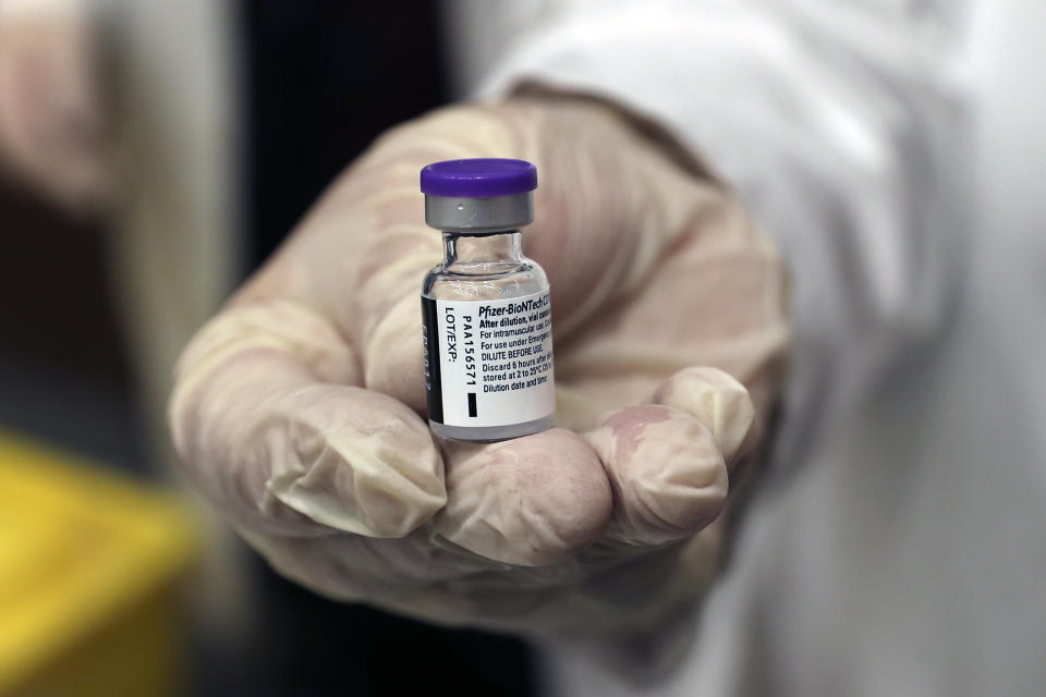 A medical staffer holds a vial of the Pfizer-BioNTech COVID-19 vaccine during a nationwide vaccination program at the American University Medical Center in Beirut, Lebanon, Sunday, Feb. 14, 2021. (AP Photo / Bilal Hussein)