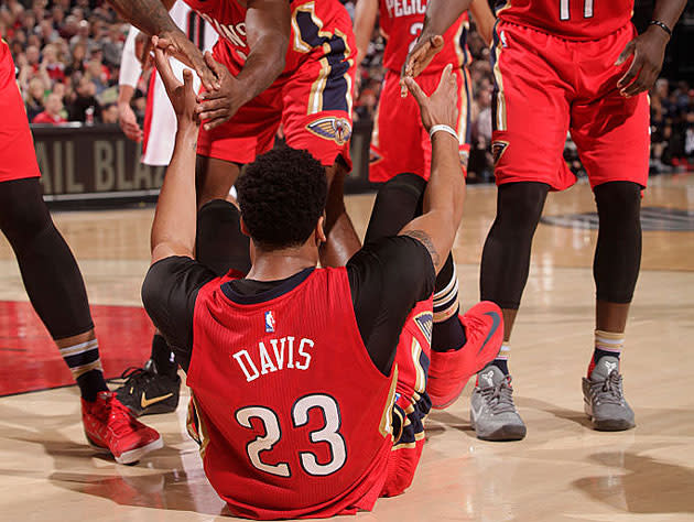 Anthony Davis, and eight arms to hold him. (Getty Images)