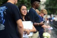 Mercedes Arias listens as they read the name of her father Joseph Amatuccio at the 9/11 Memorial during ceremonies marking the 12th anniversary of the 9/11 attacks on the World Trade Center in New York September 11, 2013. (REUTERS/Alejandra Villa)