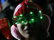 A man wearing eyewear in the shape of the year 2014 waits for a countdown event to celebrate the arrival of the the new year at the Badaling section of the Great Wall in Beijing December 31, 2013. REUTERS/Kim Kyung-Hoon (CHINA - Tags: SOCIETY ANNIVERSARY TPX IMAGES OF THE DAY)