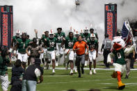 Miami head coach Manny Diaz runs onto the field with his players before an NCAA college football game against Central Connecticut State, Saturday, Sept. 25, 2021, in Miami Gardens, Fla. (AP Photo/Lynne Sladky)