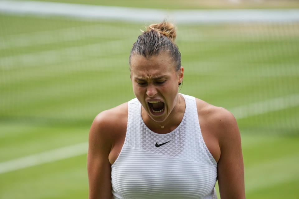 Aryna Sabalenka of Belarus reacts after losing a point to Czech Republic's Karolina Pliskova during the women's singles semifinals match on day ten of the Wimbledon Tennis Championships in London, Thursday, July 8, 2021. (AP Photo/Alberto Pezzali)