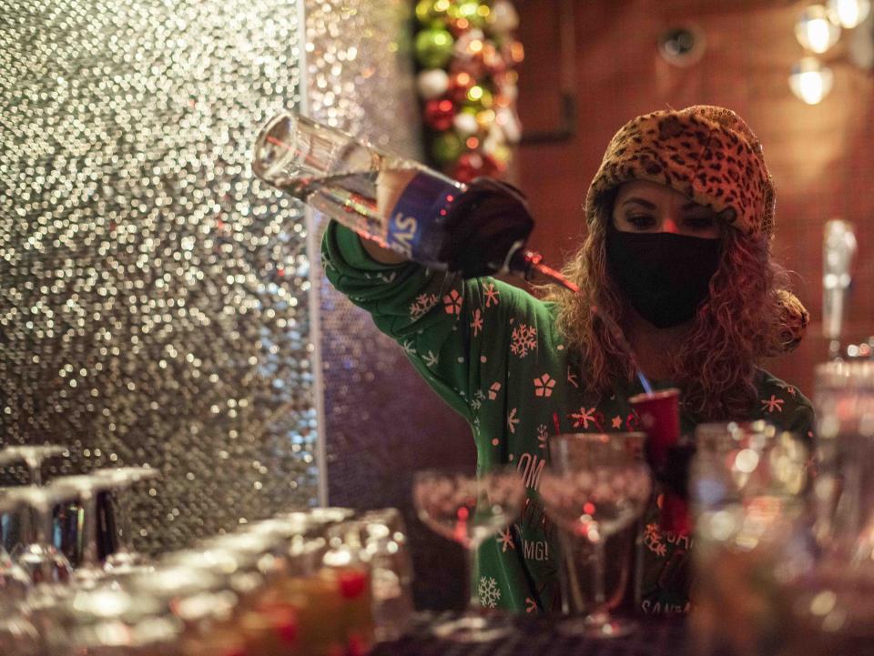 Bartender Rebecca Hollis makes a drink for a customer at the pop-up Miracle Bar at Floor 13.