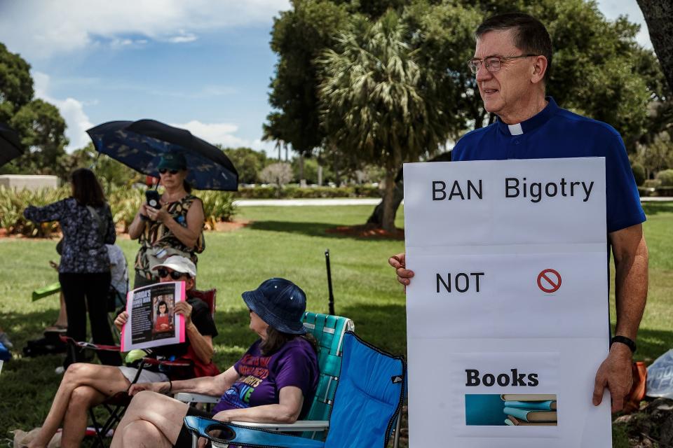 Rev. Ray Simms of Metropolitan Community Church, Palm Beach Gardens, joins other sign holders carrying messages in opposition to book bans while facing eastbound traffic on the south side of Forest Hill Boulevard outside of the The School District of Palm Beach County's Fulton-Holland Educational Services Center in Palm Springs, Fla., on July 19, 2023.