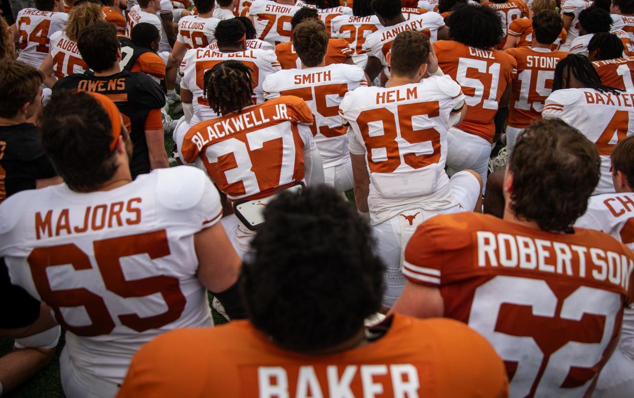 Texas players gather on the field at Royal-Memorial Stadium after Saturday's Orange-White spring game. The season opener against Colorado State is Aug. 31.