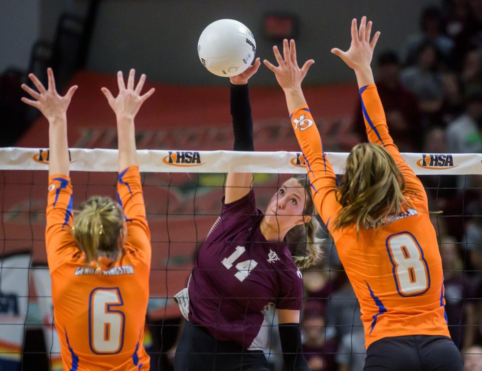 IVC's Kenna Wollard (14)  tries to put the ball past Genoa-Kingston's Kaitlin Rahn (6) and Alivia Keegan in the second set of their Class 2A volleyball state semifinal Friday, Nov. 11, 2022 at CEFCU Arena in Normal.