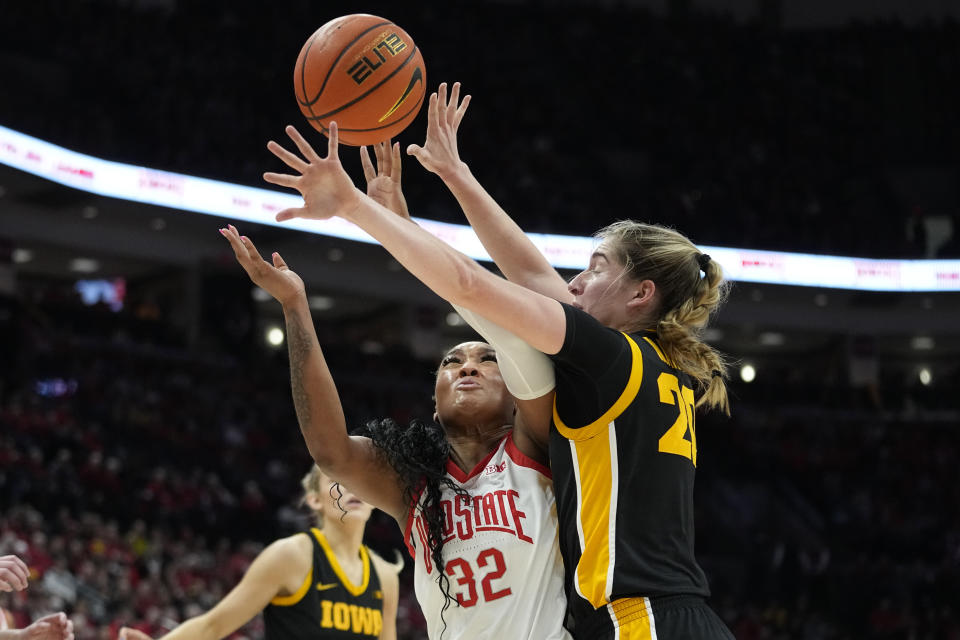 Ohio State forward Cotie McMahon shoots in front of Iowa guard Kate Martin, right, in the first half of an NCAA college basketball game Sunday, Jan. 21, 2024, in Columbus, Ohio. (AP Photo/Sue Ogrocki)