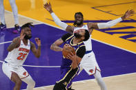 Los Angeles Lakers forward Anthony Davis, bottom right, reacts after getting hit in the face by New York Knicks center Nerlens Noel, top right, during the fourth quarter of an NBA basketball game Tuesday, May 11, 2021, in Los Angeles. New York Knicks forward Reggie Bullock (25) is at left. (AP Photo/Ashley Landis)