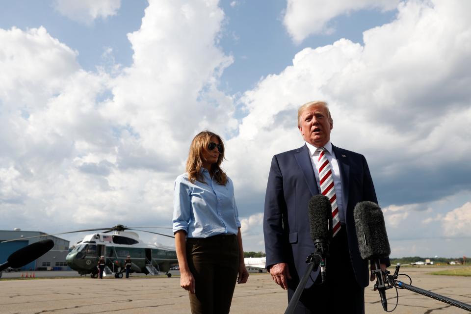 President Donald Trump, with first lady Melania Trump, speaks to the media before boarding Air Force One in Morristown, N.J., Sunday, Aug. 4, 2019.