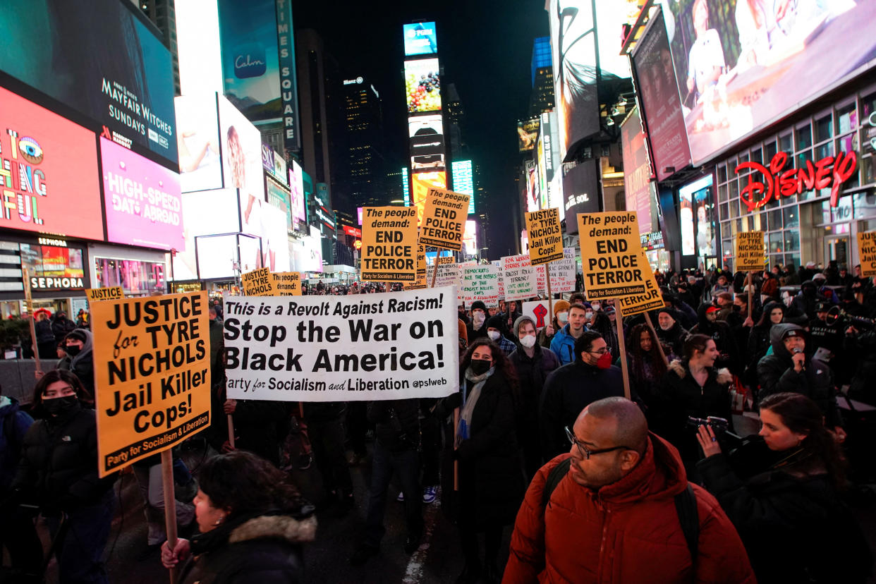 People hold signs at a protest in Times Square saying: This is a Revolt Against Racism: Stop the War on Black America; The people demand: End Police Terror; and Justice for Tyre Nichols, Jail Killer Cops, Party for Socialism & Liberation.