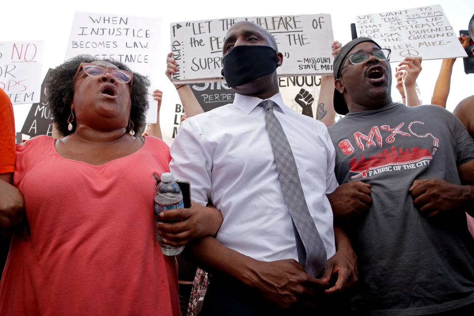 Kansas City Mayor Quinton Lucas, center, stands with protesters Wednesday, June 3, 2020, in Kansas City, Mo., during a unity march to protest against police brutality following the death of George Floyd, who died after being restrained by Minneapolis police officers on May 25.