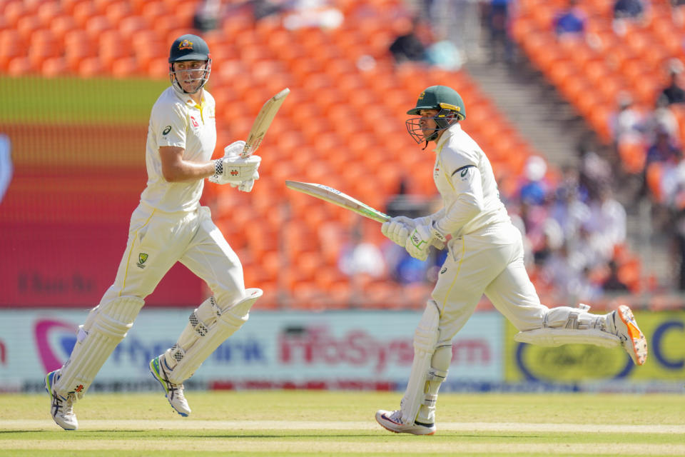 Australia's Cameron Green, left, and Usman Khawaja run between the wickets to score during the second day of the fourth cricket test match between India and Australia in Ahmedabad, India, Friday, March 10, 2023. (AP Photo/Ajit Solanki)