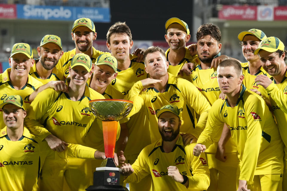 Australia's David Warner, center, gestures as he and teammates pose with the winners trophy after their win in the third and last one day international cricket match against India in Chennai, India, Wednesday, March 22, 2023. Australia won the series 2-1. (AP Photo/Aijaz Rahi)