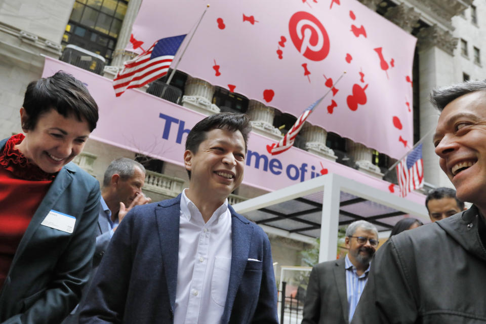 Pinterest co-founder & CEO Ben Silbermann, center, gathers with company employees outside the New York Stock Exchange, Thursday, April 18, 2019, before the Pinterest IPO. (AP Photo/Richard Drew)
